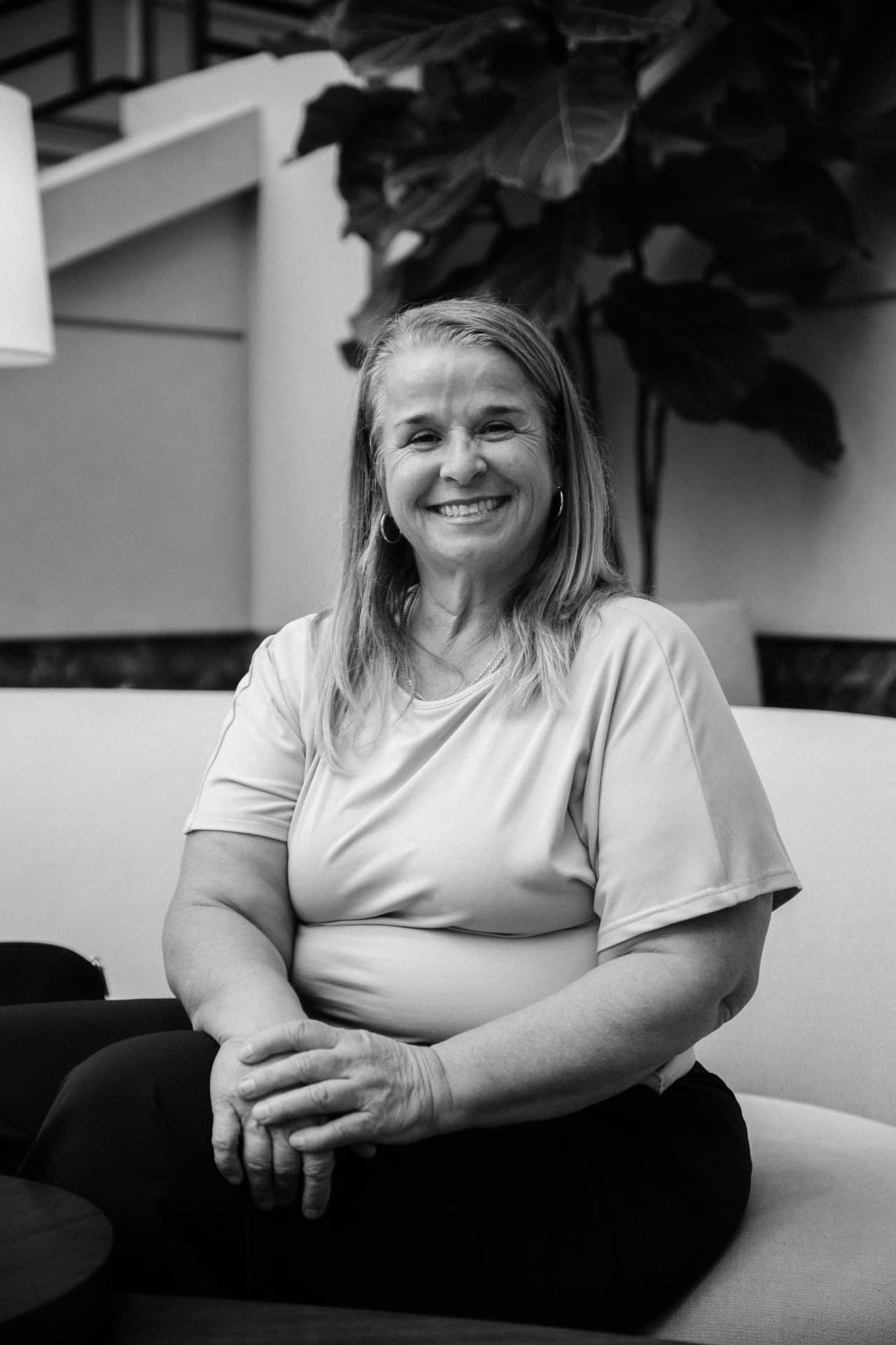 Yodi Richeson seated with her hands folded, smiling, in black and white