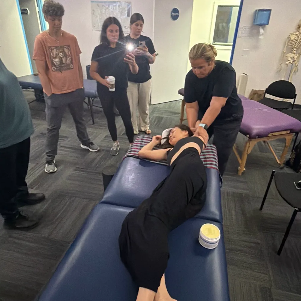 Yodi Richeson demonstrating a technique while a group of practitioners watches