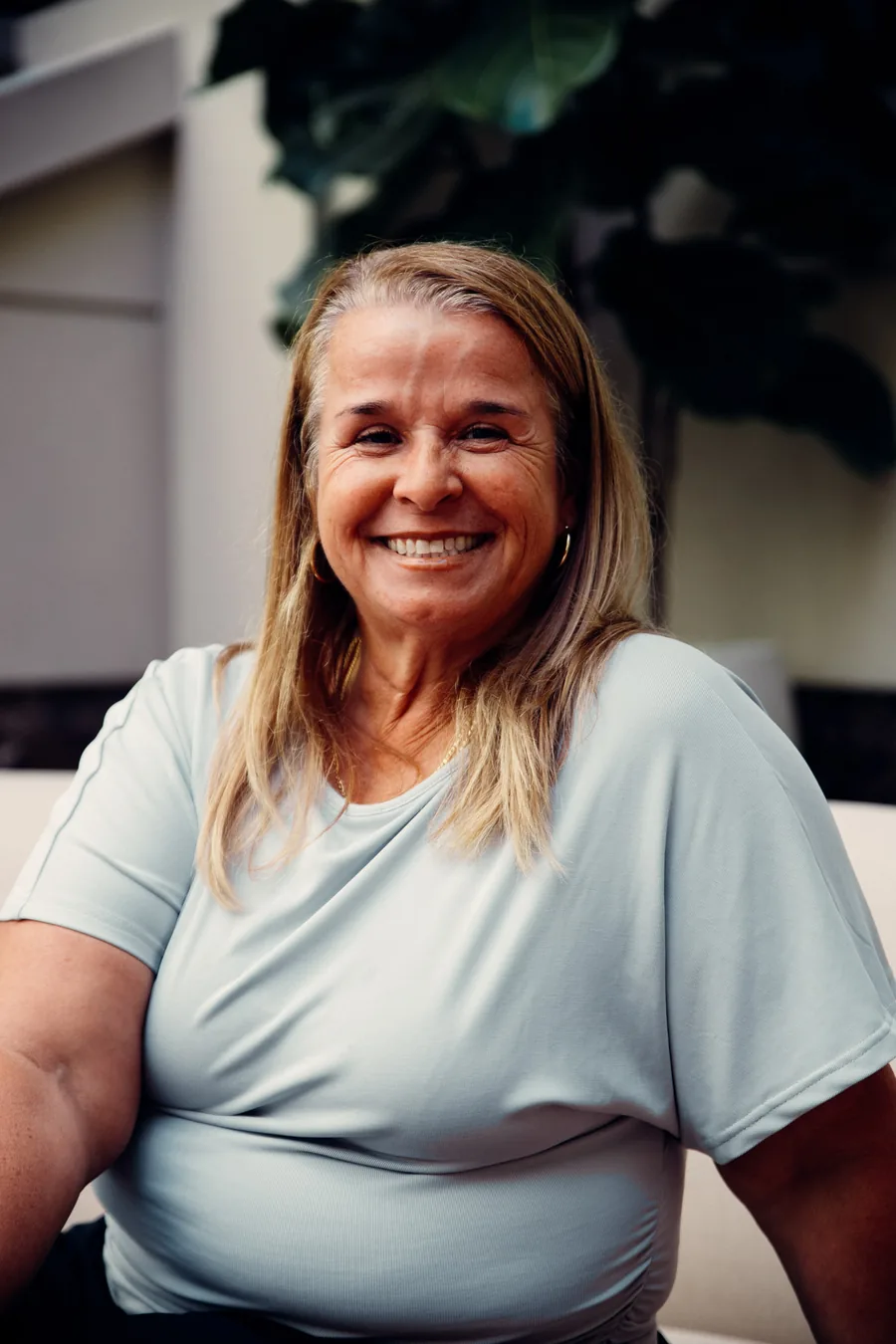 Yodi Richeson smiling, seated in a bright lounge