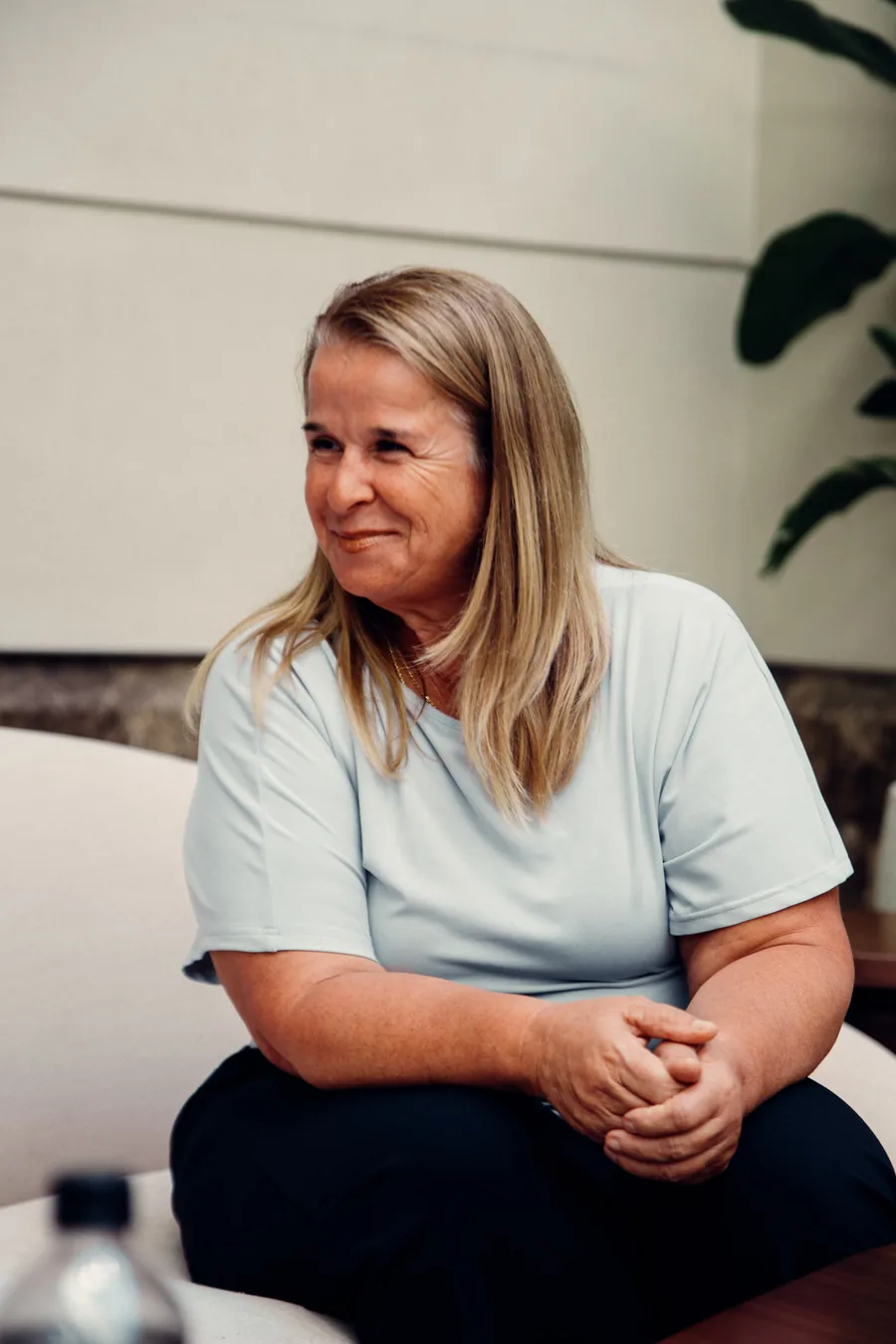 Yodi Richeson seated with her hands clasped, glancing to the side